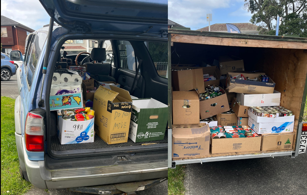 Picture of a car load and trailer load of canned food and supplies in boxes