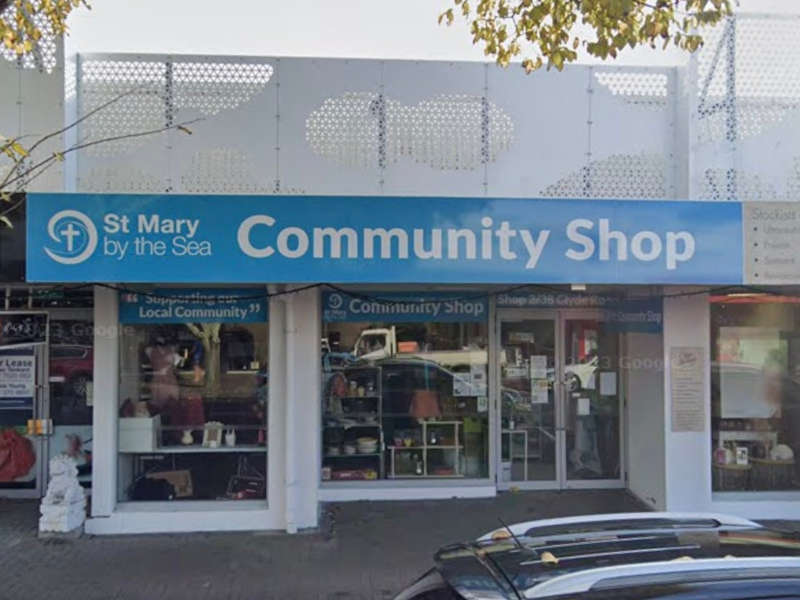 Road frontage picture of St Mary by the Sea Community Shop, showing windows and sign